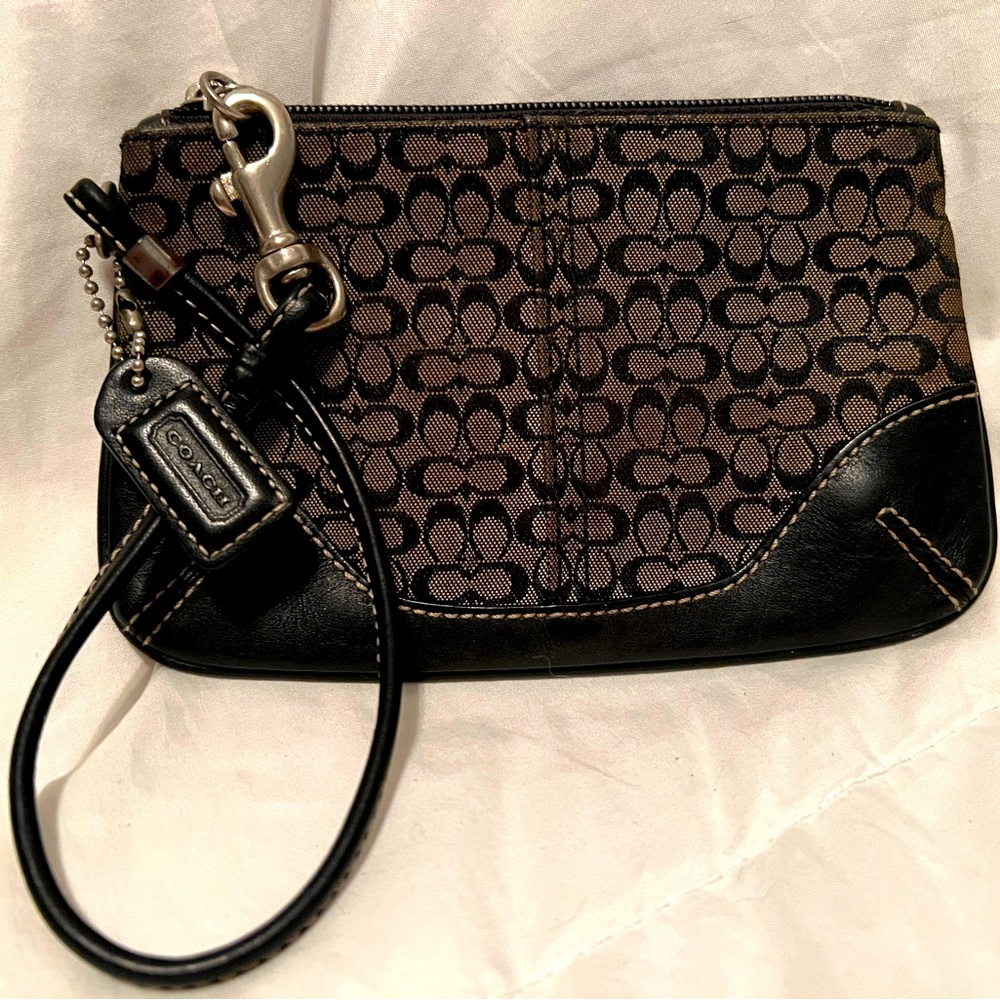 Coach Woman’s wristlet , dark brown and light brown .